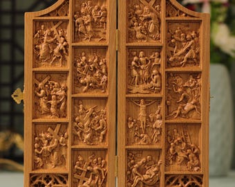 May include: A wooden carving depicting the Stations of the Cross. The carving is divided into 14 panels, each depicting a different scene from the Passion of Christ. The carving is painted in a warm brown color and has a distressed finish.