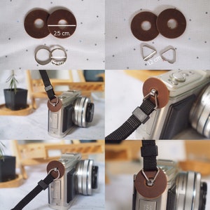 Op de afbeelding: Een bruine leren cameraband met twee bruine leren ringen, elk met een metalen lus. De band is 1,2 cm breed en de ringen hebben een diameter van 2,5 cm. De band is bevestigd aan een zilveren camera.