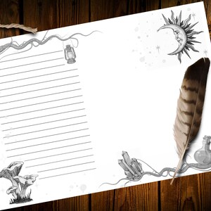 May include: A blank lined paper with a whimsical design featuring a crescent moon, sun, crystals, mushrooms, and a lantern. The paper is on a wooden surface with a feather quill and inkwell.