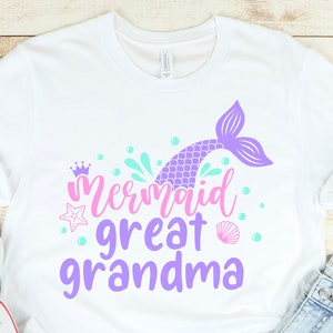 May include: White t-shirt with a purple mermaid tail and the text "Mermaid Great Grandma" in pink and purple.