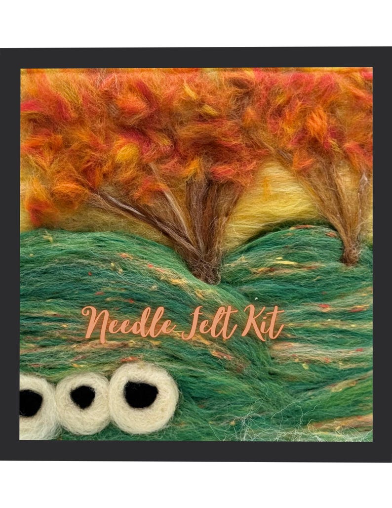 May include: A needle felt kit depicting a landscape with trees and a creature. The trees have orange and yellow leaves, and the creature has three white eyes with black pupils. The text "Needle Felt Kit" is written in a cursive font.