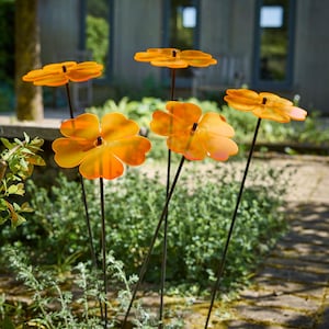 Set of 5 Double Blossom, 5 colour choice, 75cm, 29.5 inch  high, 15cm, 5.9 inch diameter. SunCatchers work without battery, drawing natural UV light, emitting glow at edges. Glowing dawn to dusk. Image shows 5 blue Double Blossoms