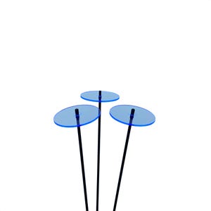 May include: Three black metal rods with blue glass discs on top. The discs are round and have a slight curve to them.