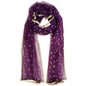 May include: A purple sheer scarf with gold trim and sequins. The scarf is folded in half and draped over a white background.