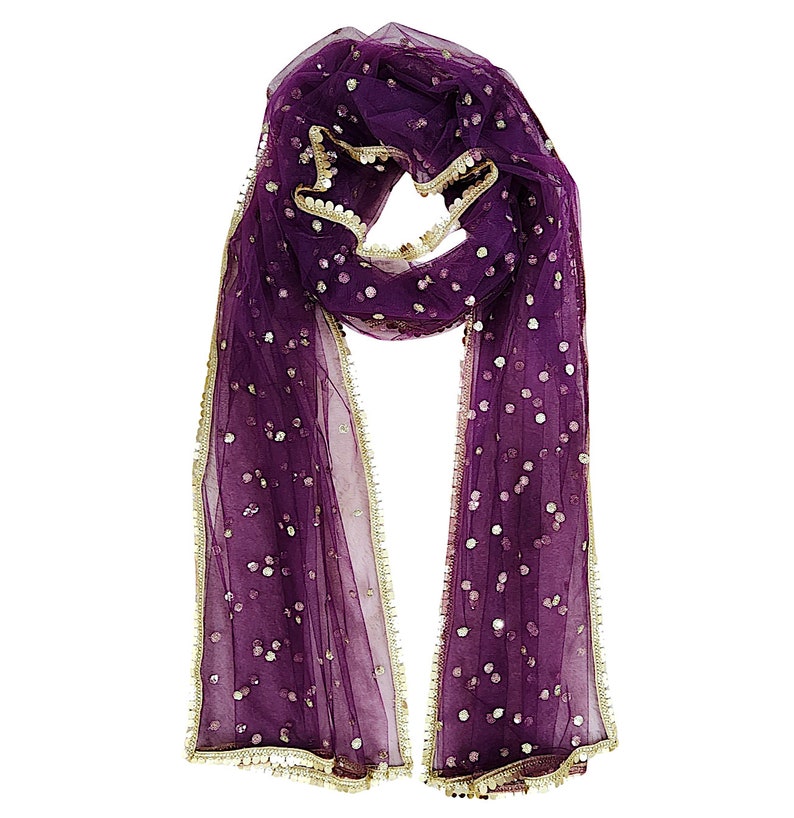 May include: A purple sheer scarf with gold trim and sequins. The scarf is folded in half and draped over a white background.