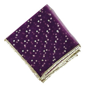 May include: A purple net scarf with gold sequins and a gold trim.