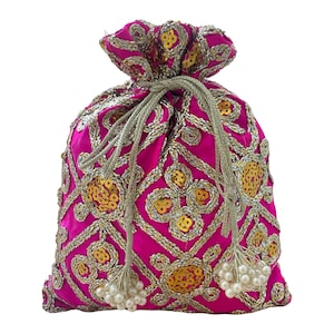 May include: A hot pink drawstring pouch with intricate gold embroidery and sequin details. The bag features a repeating geometric pattern, a cinched top, and beaded tassels. The overall design is ornate and decorative.
