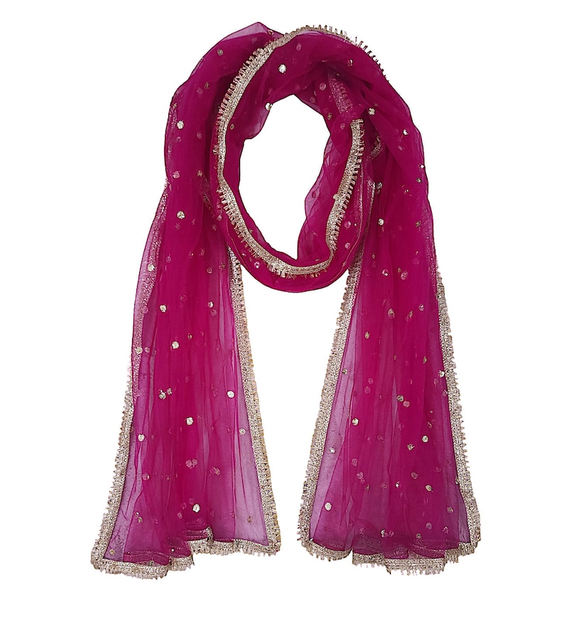 May include: A pink sheer dupatta with gold trim and sequins. The dupatta is a traditional Indian garment worn as a scarf or shawl.