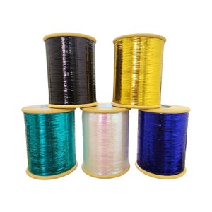 May include: Five spools of metallic thread in black, gold, teal, iridescent white, and blue. Each spool is cylindrical with a wooden base and top. The thread has a shiny, reflective quality, suitable for crafting and embellishment projects.