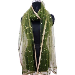 May include: A green net scarf with gold sequins and a gold trim. The scarf is draped over a mannequin.