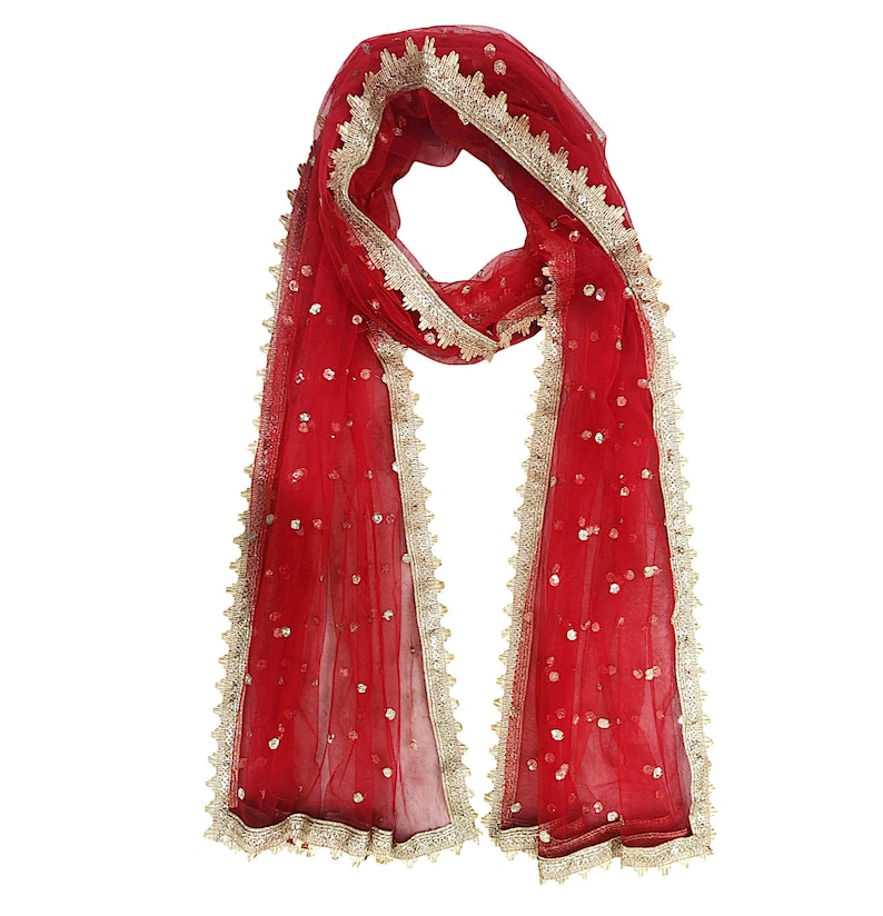 May include: A red sheer scarf with gold trim and sequins. The scarf has a delicate lace border.