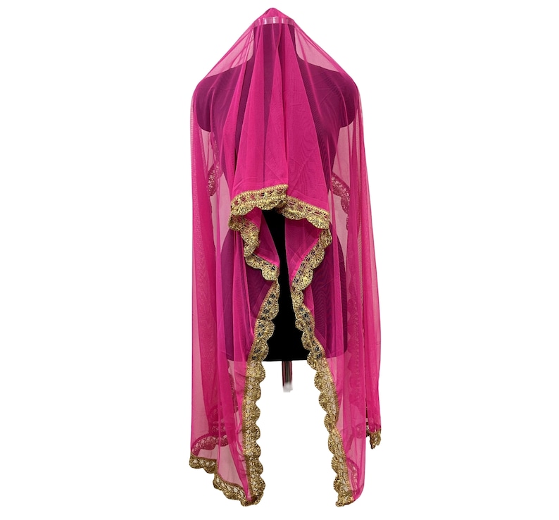 May include: A vibrant pink sheer veil with gold trim, displayed on a mannequin. The veil is draped to showcase its flowing design and intricate gold detailing along the edges, creating an elegant look.