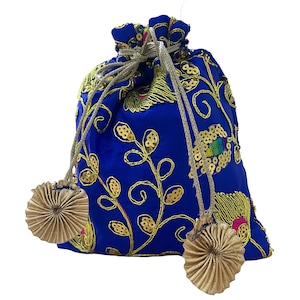 May include: A royal blue drawstring pouch with gold floral embroidery and sequin accents. The bag features a gold drawstring closure and two decorative gold tassel-like embellishments. The pouch is likely made of a soft, silky fabric.