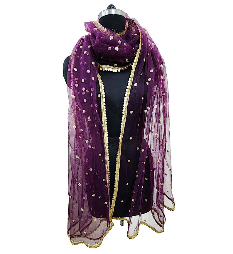 May include: A purple net dupatta with gold sequins and a gold border. The dupatta is draped over a mannequin.