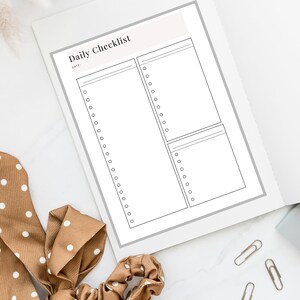 May include: A printable daily checklist with a blank space for the date and three sections with blank lines for writing tasks. The checklist is on a white background.
