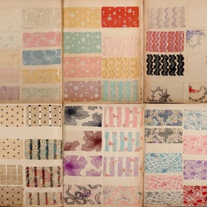 May include: A vintage fabric sample book with a variety of patterns and colors. The book is open to two pages, each with 12 fabric swatches. The swatches are arranged in rows and columns, and each swatch has a different pattern and color. The patterns include polka dots, stripes, floral prints, and geometric designs. The colors include pink, blue, green, yellow, red, and black.