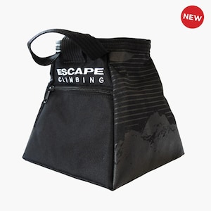 May include: Black climbing chalk bag with a zipped pocket and a white "ESCAPE CLIMBING" logo. The bag features a black and white mountain range design.