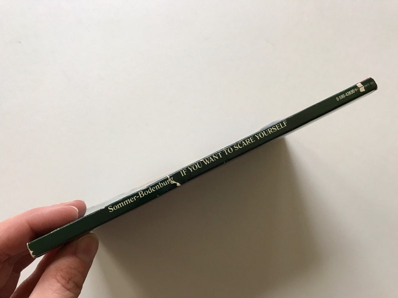 May include: A green paperback book with the title "If You Want To Scare Yourself" and the author "Sommer-Bodenburg" on the spine.