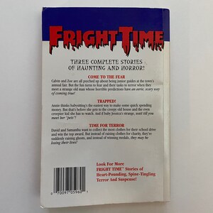 May include: A book cover for "Fright Time" with a red, white, and blue colour scheme. The title is in a bold, white font with a dripping effect. The back cover features three stories of haunting and horror: "Come to the Fear", "Trapped!" and "Time for Terror".