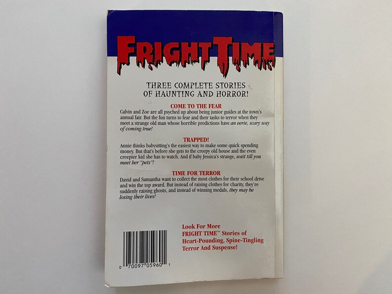 May include: A book cover for "Fright Time" with a red, white, and blue colour scheme. The title is in a bold, white font with a dripping effect. The back cover features three stories of haunting and horror: "Come to the Fear", "Trapped!" and "Time for Terror".