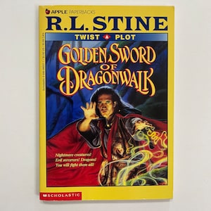 May include: A yellow paperback book cover with a red apple logo and the title "R.L. Stine Twist A Plot Golden Sword of Dragonwalk". The cover features a man in a red and black robe with a green and yellow magical effect behind him. The text on the cover reads "Nightmare creatures! Evil sorcerers! Dragons! You will fight them all!"