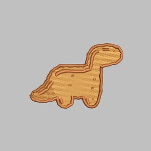 Puede incluir: Parche bordado con un diseño de dinosaurio marrón claro. El dinosaurio está delineado con un hilo marrón más oscuro, con detalles como los ojos y la textura del cuerpo. El parche es probablemente para ropa o accesorios.