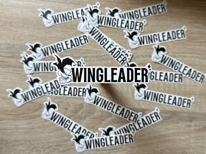 May include: A collection of black and white stickers with the word "WINGLEADER" repeated multiple times. The stickers feature a cartoon bird with a cloud design.