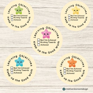 May include: Four yellow circular stickers with a cartoon starfish and the text "Learning Objectives Keep up the Good Work" and three checkboxes labelled "Not Yet Achieved", "Working Towards", and "Achieved".