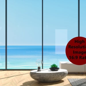 May include: A modern living room with a large window overlooking the ocean. The room features a white sofa, a stone coffee table, and decorative objects. A red circle with text indicates a high-resolution image with a 16:9 ratio.