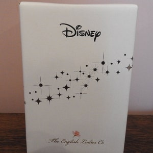 May include: White box with a black Disney logo and a pattern of black stars. The box also has the text "The English Ladies Co."