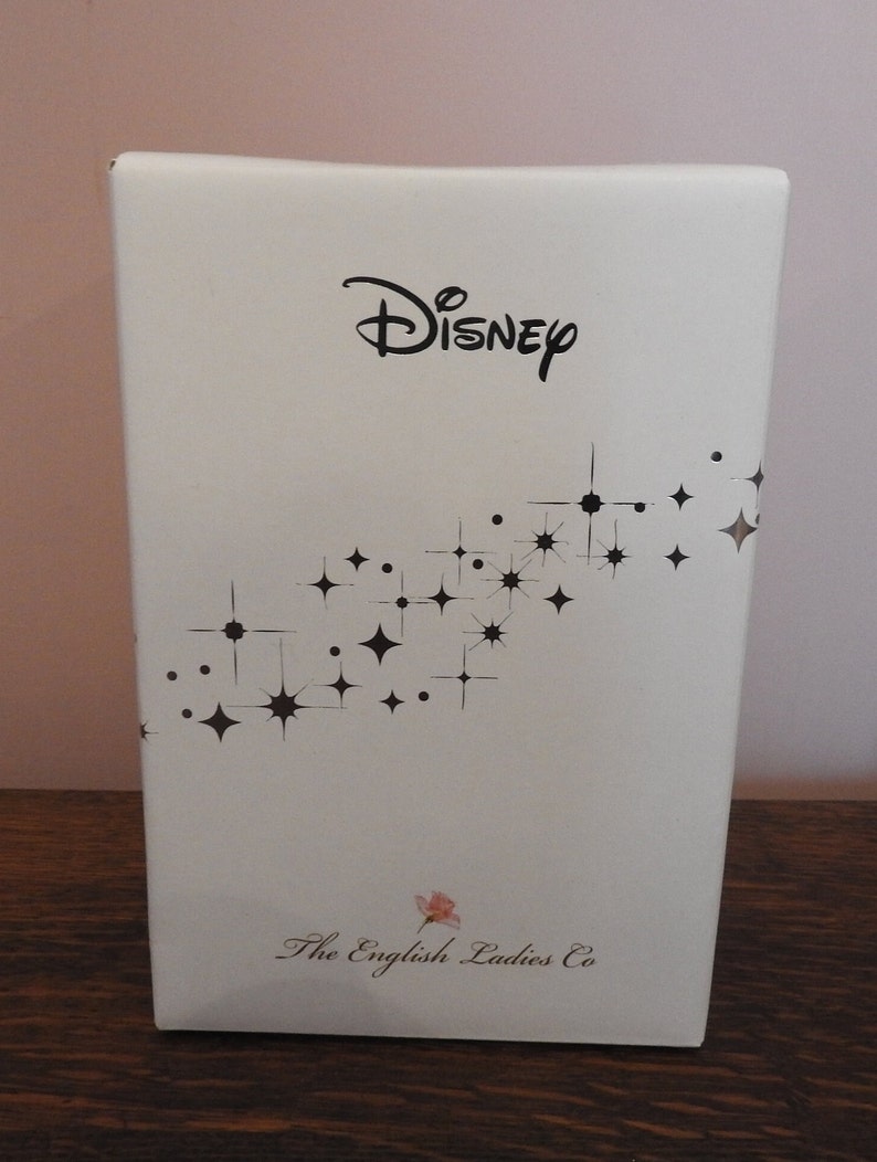 May include: White box with a black Disney logo and a pattern of black stars. The box also has the text "The English Ladies Co."