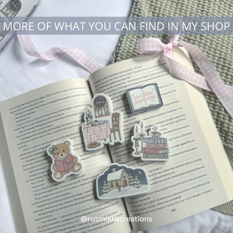 May include: A collection of illustrated stickers featuring a cozy winter scene with a house, a bear reading a book, a table setting, and a stack of books with candles. The stickers are on a book with text about a Christmas story.