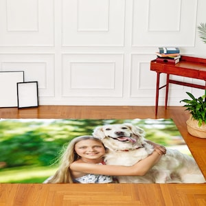 May include: A girl hugs a white dog in a green grassy field. The girl has long blonde hair and is wearing a white tank top. The dog has a black collar and is looking at the camera.