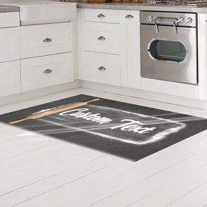 May include: A black and white kitchen rug with a rolling pin and the text "Custom Text" written in white on a gray background.