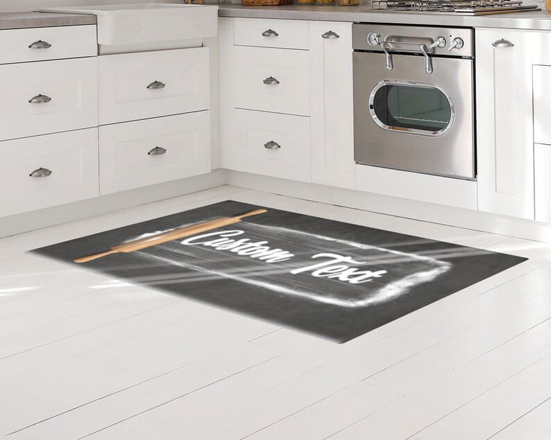 May include: A black and white kitchen rug with a rolling pin and the text "Custom Text" written in white on a gray background.