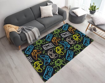 May include: A black and white rug with a repeating pattern of colorful video game controllers. The controllers are outlined in blue, green, and yellow.