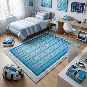 May include: A bedroom with a blue and white striped bedspread, matching pillows, and a rug designed to look like a swimming pool. The room also features a desk, chair, and artwork with a water theme. A duffel bag sits on the floor.