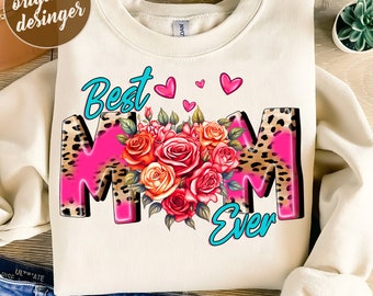 May include: Cream-colored sweatshirt with the words "Best Mom Ever" in turquoise and pink, with a floral bouquet and leopard print accents. The design includes pink hearts. The text "original designer" is in the upper left corner.