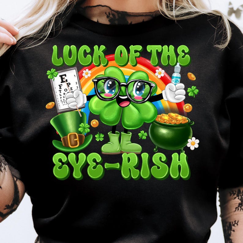 May include: Black t-shirt with a green shamrock wearing glasses and holding an eye chart. The text "Luck of the Eye-rish" is written in green and white letters.