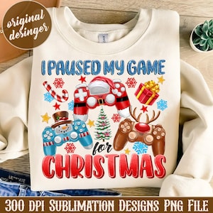 May include: A white sublimation design featuring a Christmas-themed video game controller with the text "I Paused My Game for Christmas".