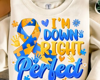 May include: A cream-colored sweatshirt with a blue and yellow puzzle piece ribbon, handprints, and the text "I'm Down Right Perfect".