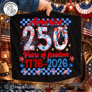 May include: Black t-shirt with a patriotic design celebrating America's 250th anniversary. The design includes the word "America", the number "250", and the years "1776-2026" in red, white, and blue. Fireworks and stars complete the design.