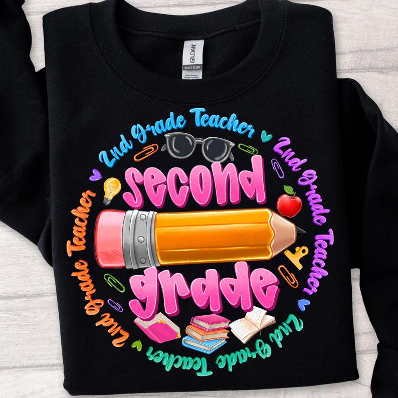 May include: Black sweatshirt with a colorful graphic design for a 2nd-grade teacher. The design includes a large pencil, the words "Second Grade", and other school-related icons like glasses, an apple, and books.