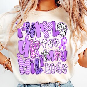 May include: A purple t-shirt with the text "Purple Up for Military Kids" in a colourful, patterned font. The text is surrounded by purple ribbons and stars.