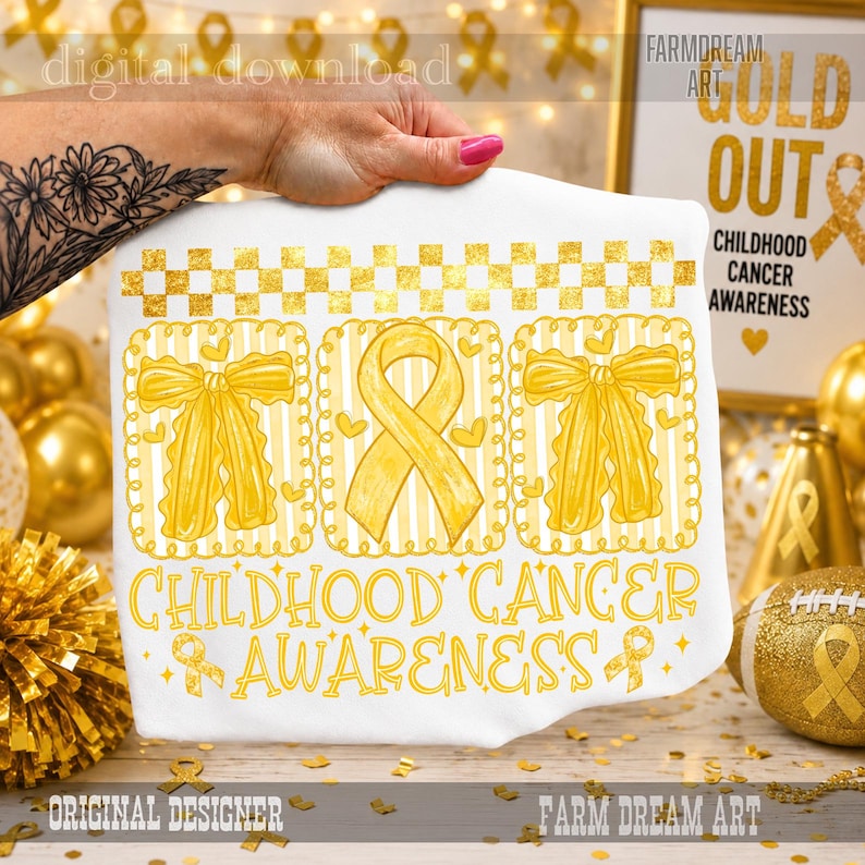 May include: A white fabric item featuring a gold-colored graphic with a checkered border, two bows, and a central awareness ribbon. The text reads Childhood Cancer Awareness. The design includes small heart shapes and a repeating ribbon pattern.