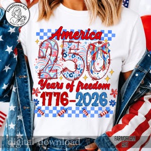 May include: White t-shirt with a patriotic design celebrating 250 years of American freedom. The design features the word "America" in red, the number "250" with stars and stripes, and the years "1776-2026". Includes fireworks and floral accents.