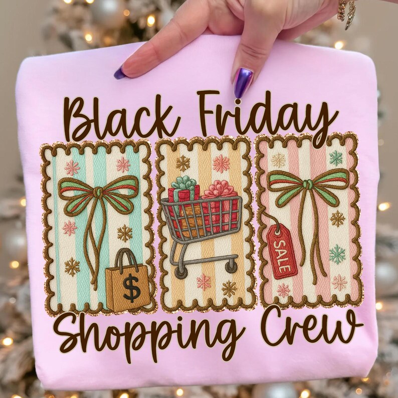 May include: A light pink sweatshirt with the words "Black Friday Shopping Crew" in brown script. The design includes three framed illustrations with bows, a shopping cart, a gift bag, and a sale tag.