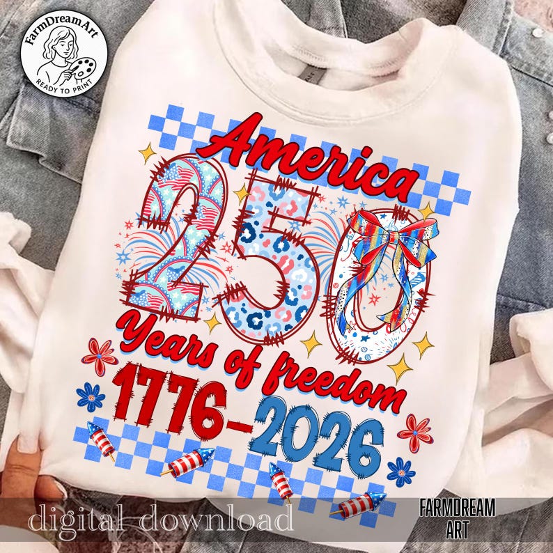 May include: White sweatshirt with a patriotic design celebrating America's 250th anniversary. The design features the word "America" in red script, the number "250" with a mix of patterns, and the text "Years of freedom 1776-2026".