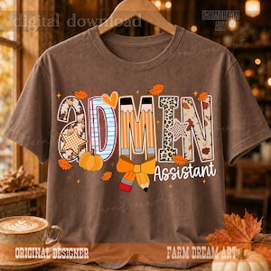 May include: A brown short-sleeve t-shirt featuring the text ADMIN Assistant in a decorative font. The letters are filled with patterns including leopard print, autumn leaves, and pencil designs, accented by a pumpkin, a bow, and stars.