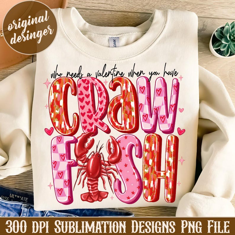 May include: A white sweatshirt with a Valentine's Day themed design. The text reads "Who needs a valentine when you have crawfish". The design features a red crawfish with pink and red hearts and checkered patterns.